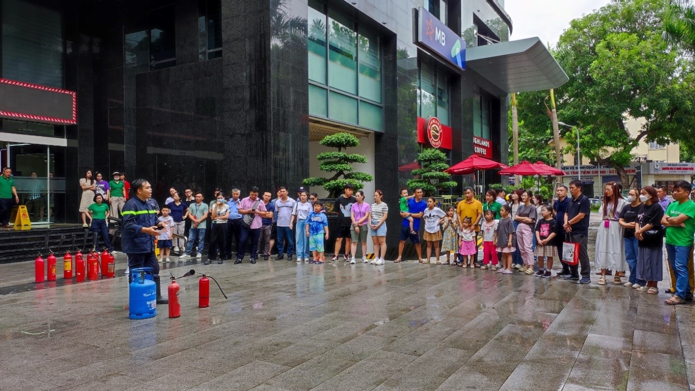 A group of people standing in a line outside of a building

Description automatically generated